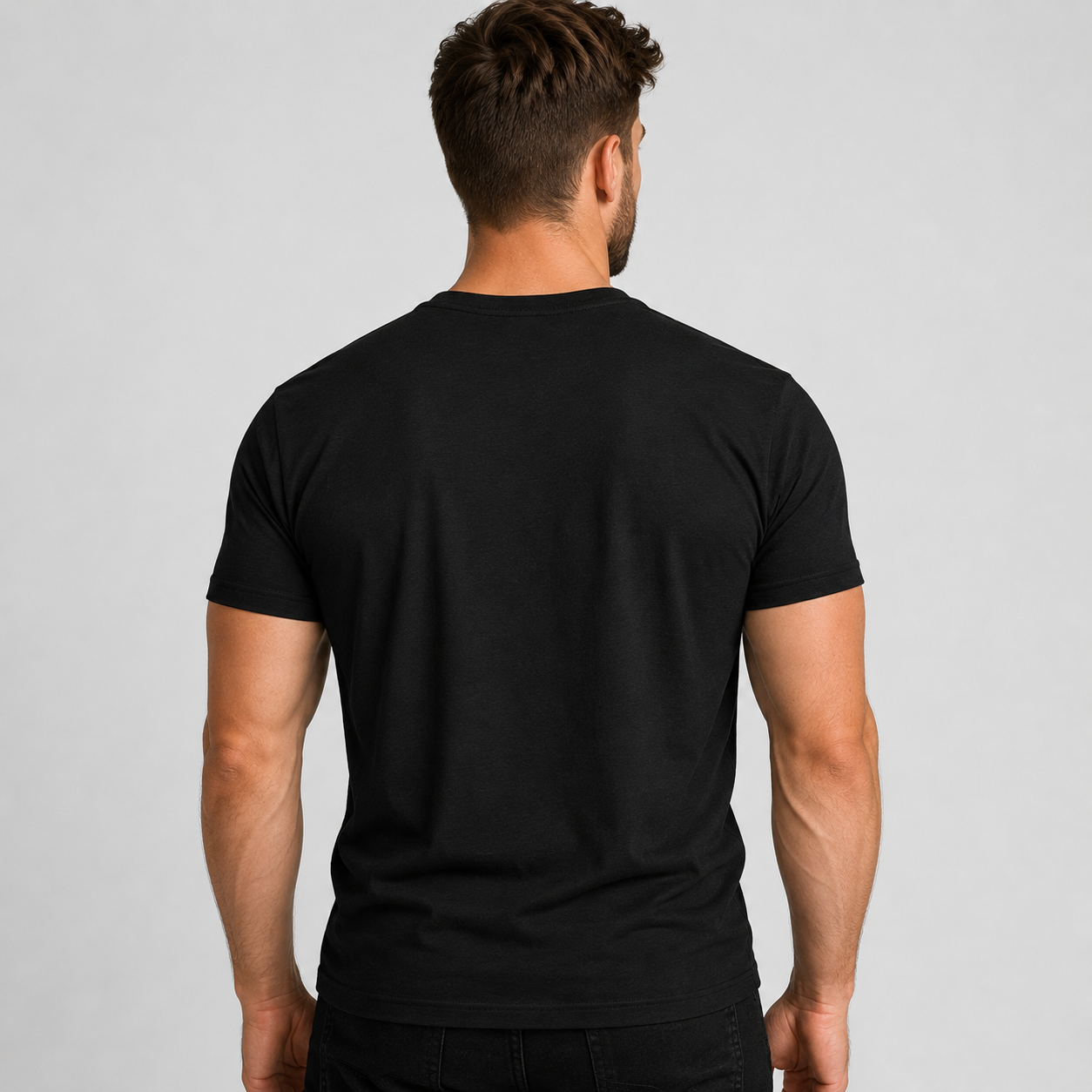 Man wearing a black t-shirt against a gray background