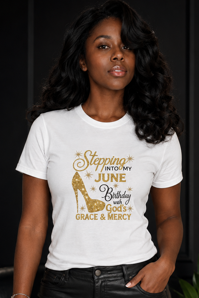 Woman wearing a white t-shirt with gold text and design, standing against a dark background.
