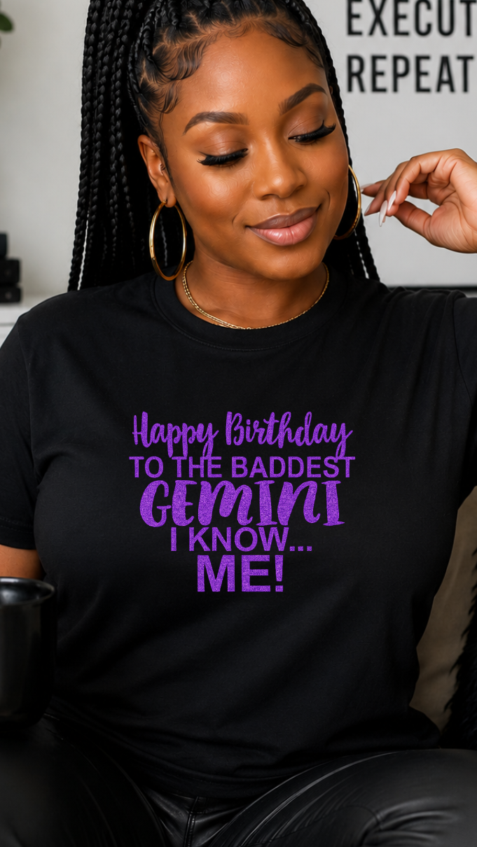 Woman wearing a black t-shirt with purple text, sitting on a couch holding a mug.