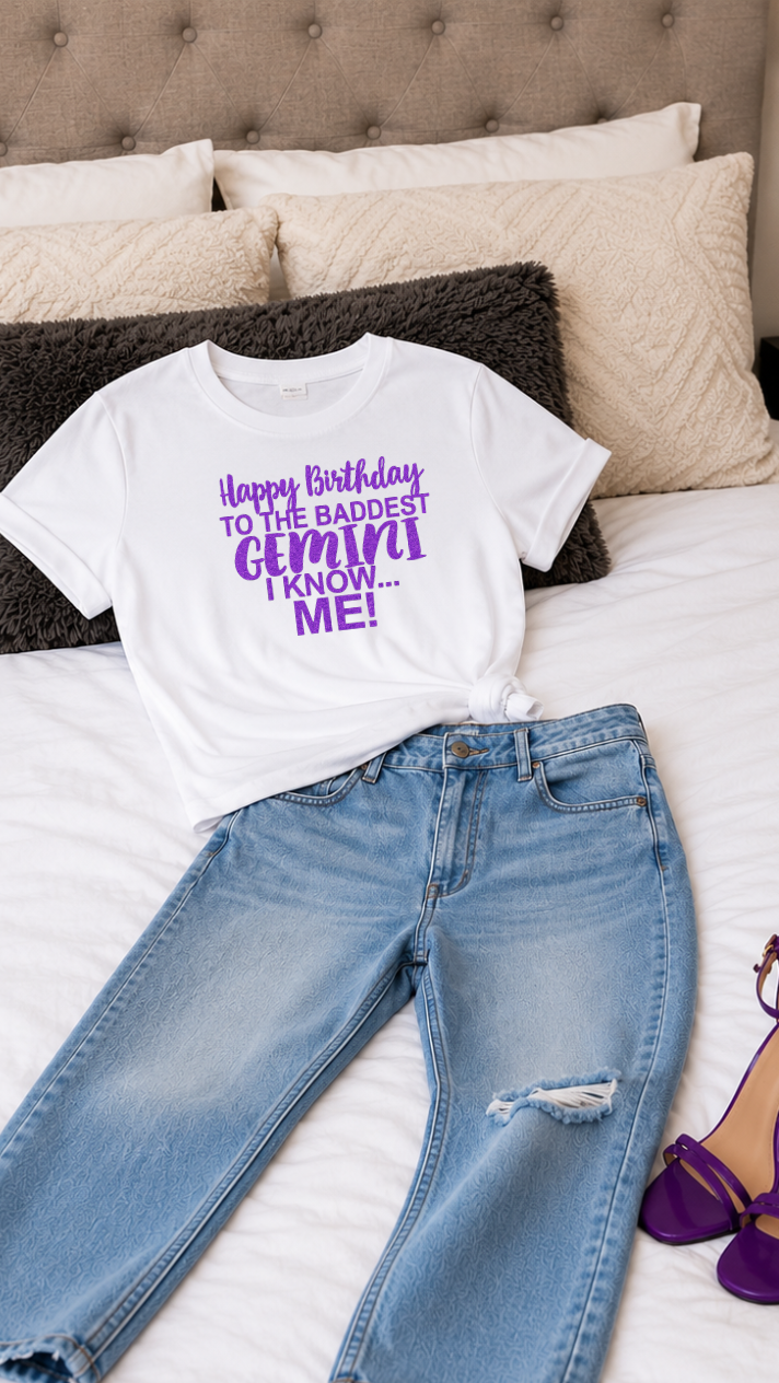 White t-shirt with purple text, blue jeans, and purple high heels on a bed.